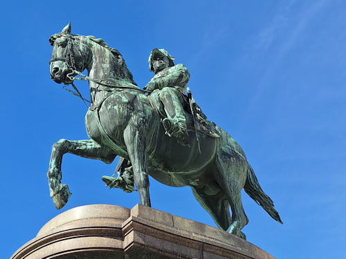 Equestrian statue in front of a blue sky