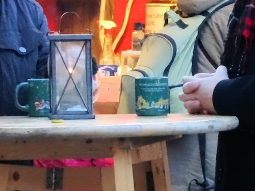 Bar table with a lantern and Christmas punch mugs