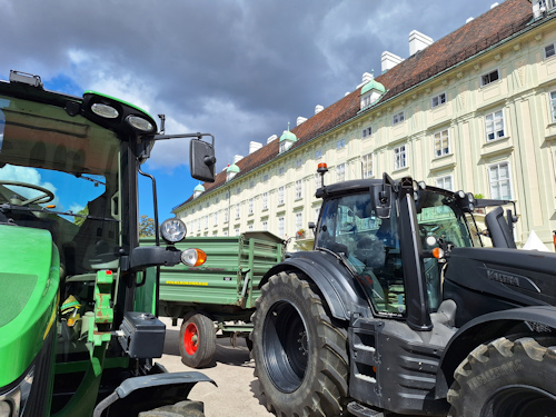 Tractors in front of a historical building