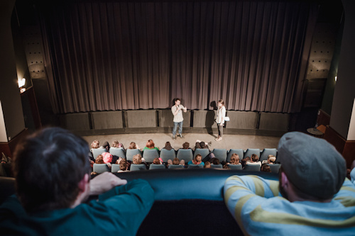two people giving a talk in a cinema
