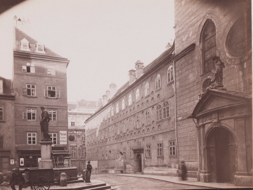 Photo of a monastery and church entrance in front of a small square