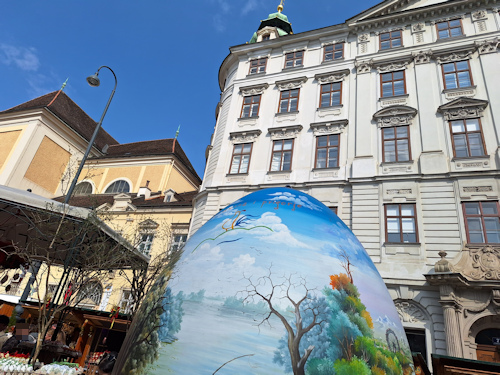 Giant decorated Easter egg in front of historical buildings