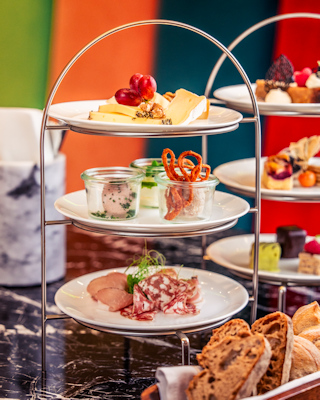 Three-tiered serving plate with meat and cheese