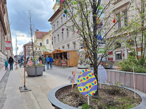 View up a market alley with egg decorations in the foreground