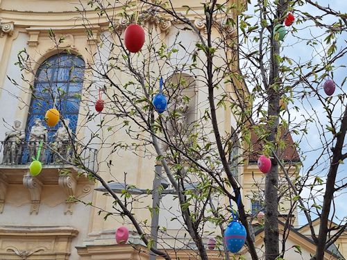 Tree decorated with eggs with a church façade behind
