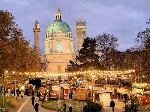 View across a Christmas market with a church behind