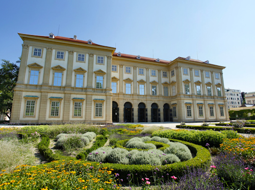 Sculpted flowerbed with a historical building behind