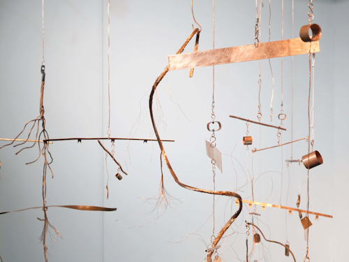Metal objects hanging in an art installation