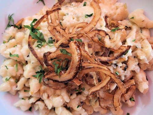 Käsespätzle dish with fried onions