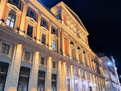 View of the rear of the Musikverein and piano store at night
