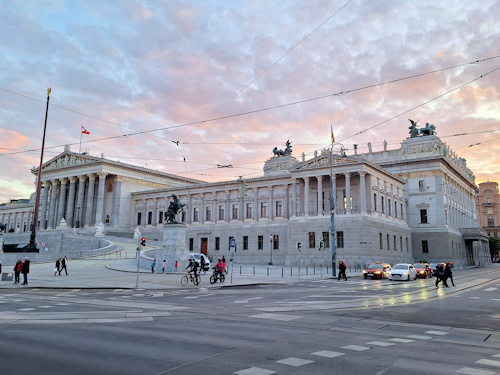 Full view of the Austrian parliament building at dusk