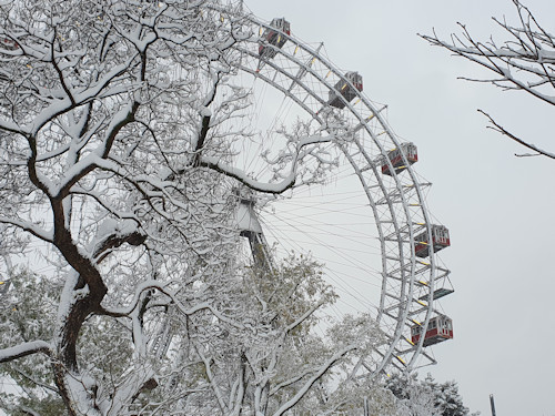The Riesenrad in the snow seen through the trees