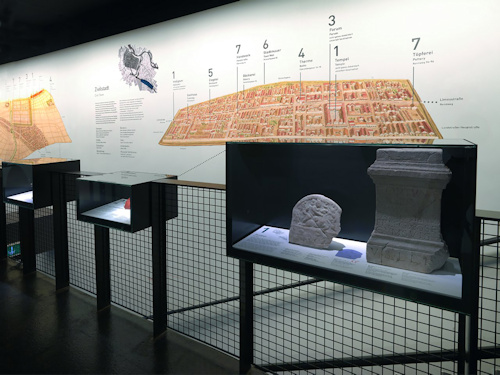 Museum display with a map of a Roman town and artefacts