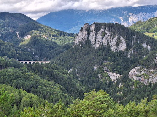 View of mountains, forests, and railway bridges