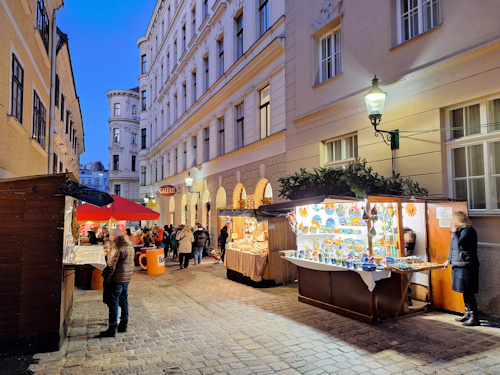 Side street with market booths at dusk