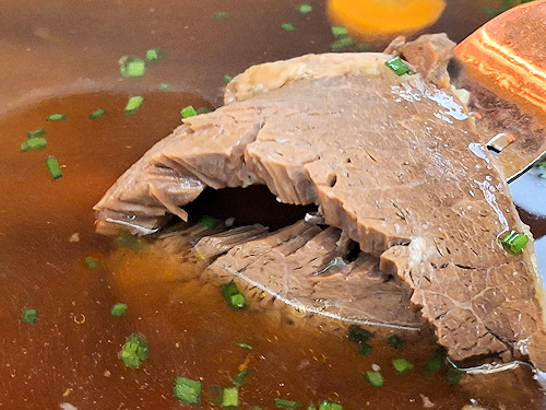 The soft meat of Tafelspitz on a fork