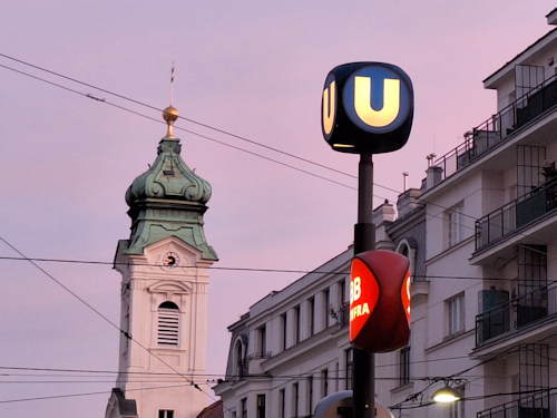 Ubahn sign with a historical tower behind